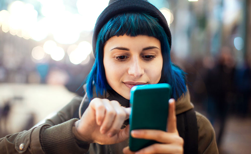 young woman investing on phone