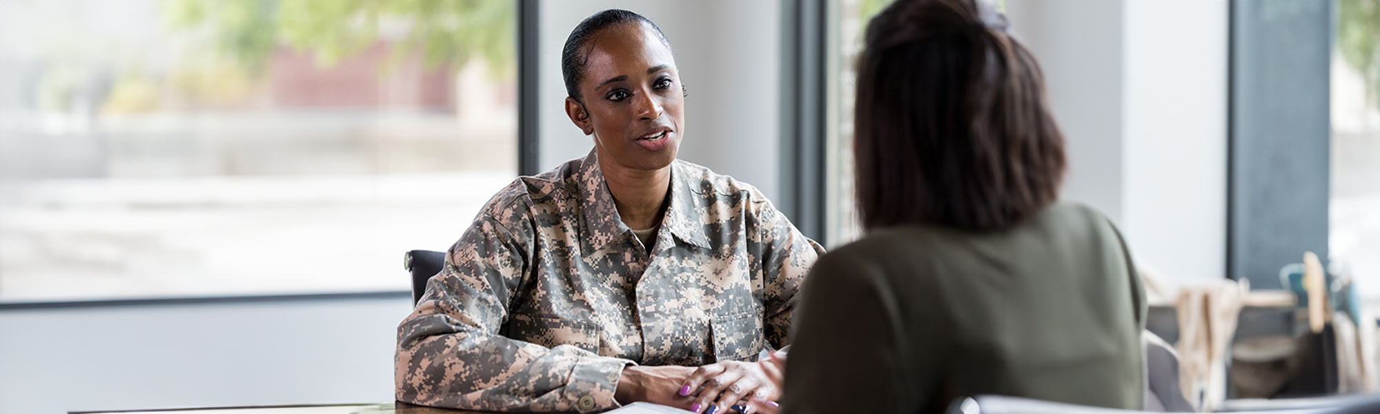 Female military veteran talking to credit union representative