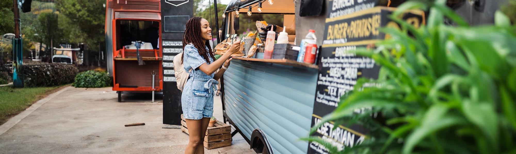 woman getting food from a food truck