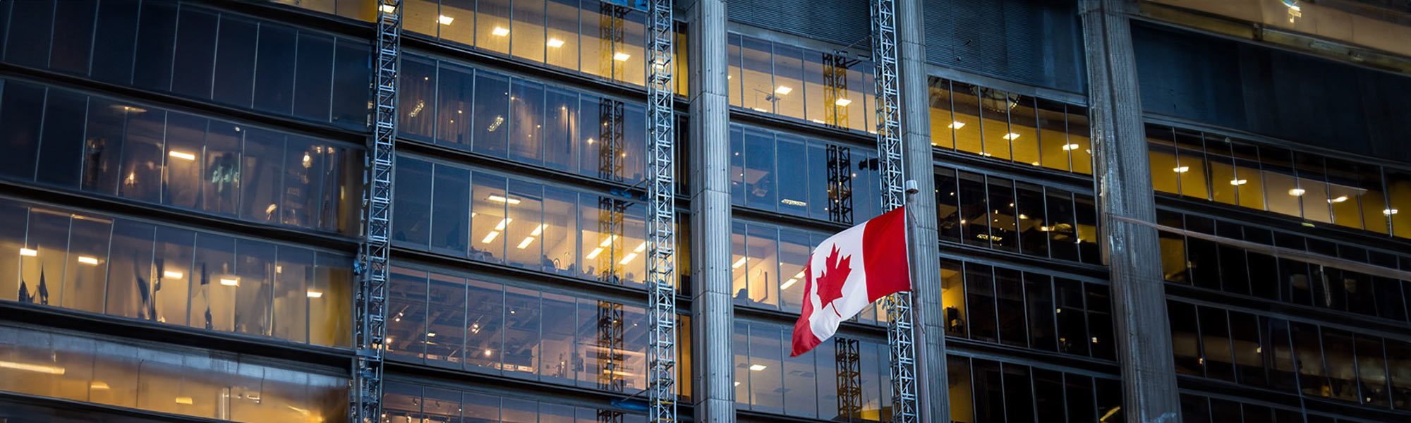 canadian flag flying outside of building