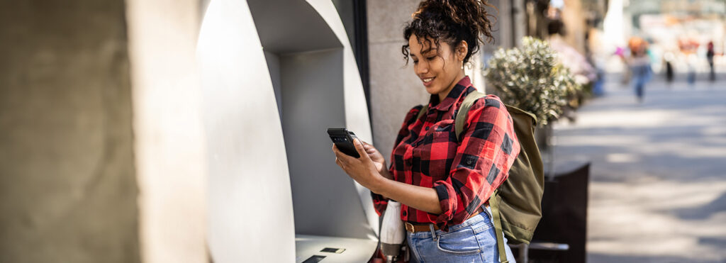woman using an ATM outdoor