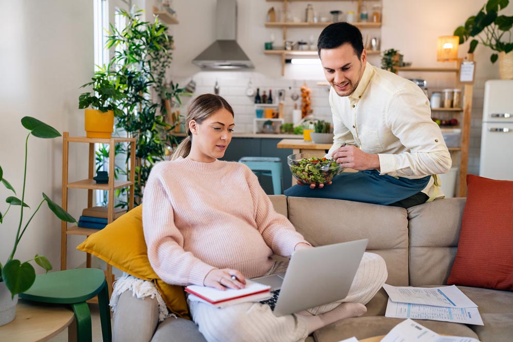 Pregnant couple doing banking online