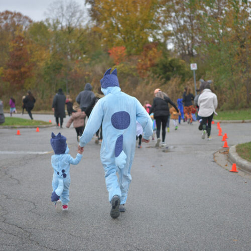 Father and Son Dressed as Bluey doing the trick or trot