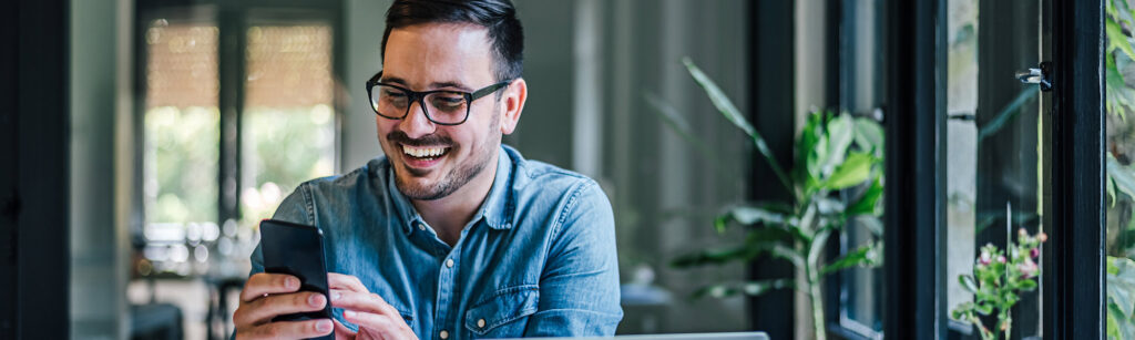 Adult male on computer and phone enjoying browsing the web