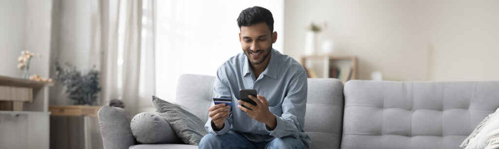 man using credit card online with phone