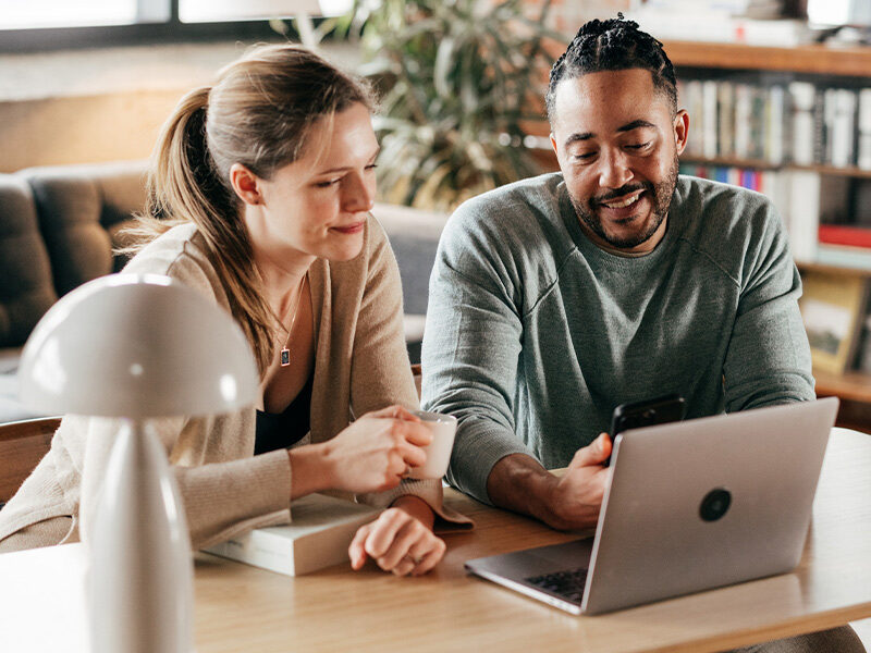 man and woman couple on laptop in house