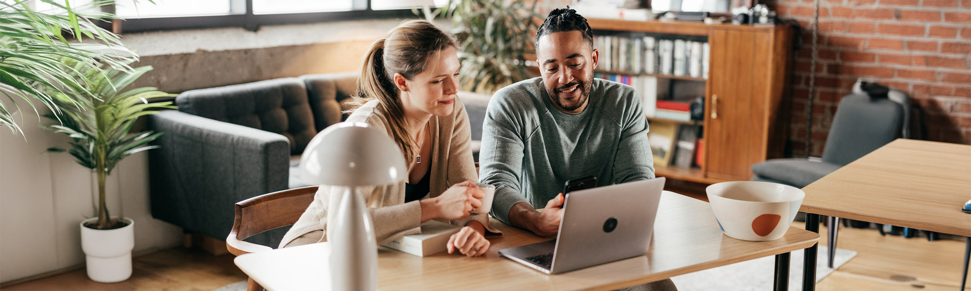 man and woman couple on laptop in house