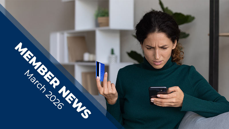 Promotional graphic showing a person seated on a couch holding a credit card and a smartphone, with a blue banner reading ‘Member News March 2026’ overlaid on the left.