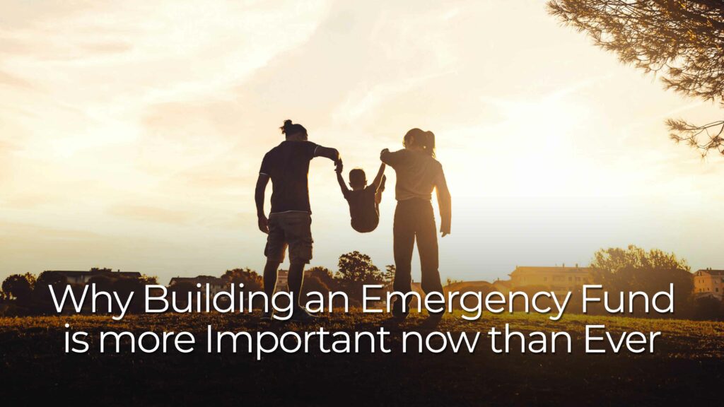 Silhouettes of two adults holding hands with a small child raised between them in an outdoor field at sunset. Large text over the image reads “Why Building an Emergency Fund is more Important now than Ever.”